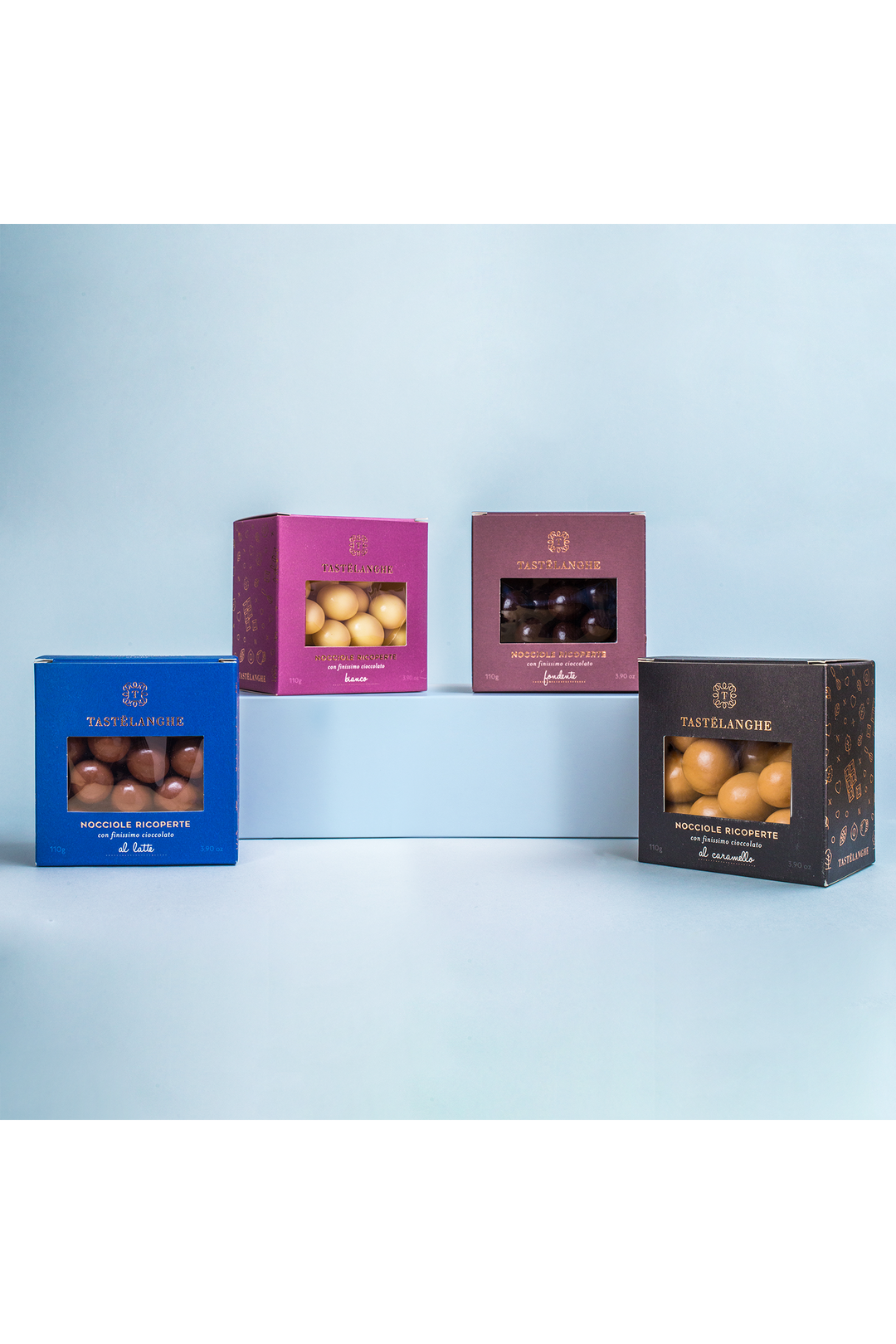 Quattro confezioni Tastëlanghe di nocciole ricoperte di cioccolato, nei gusti latte, bianco, fondente e caramello.